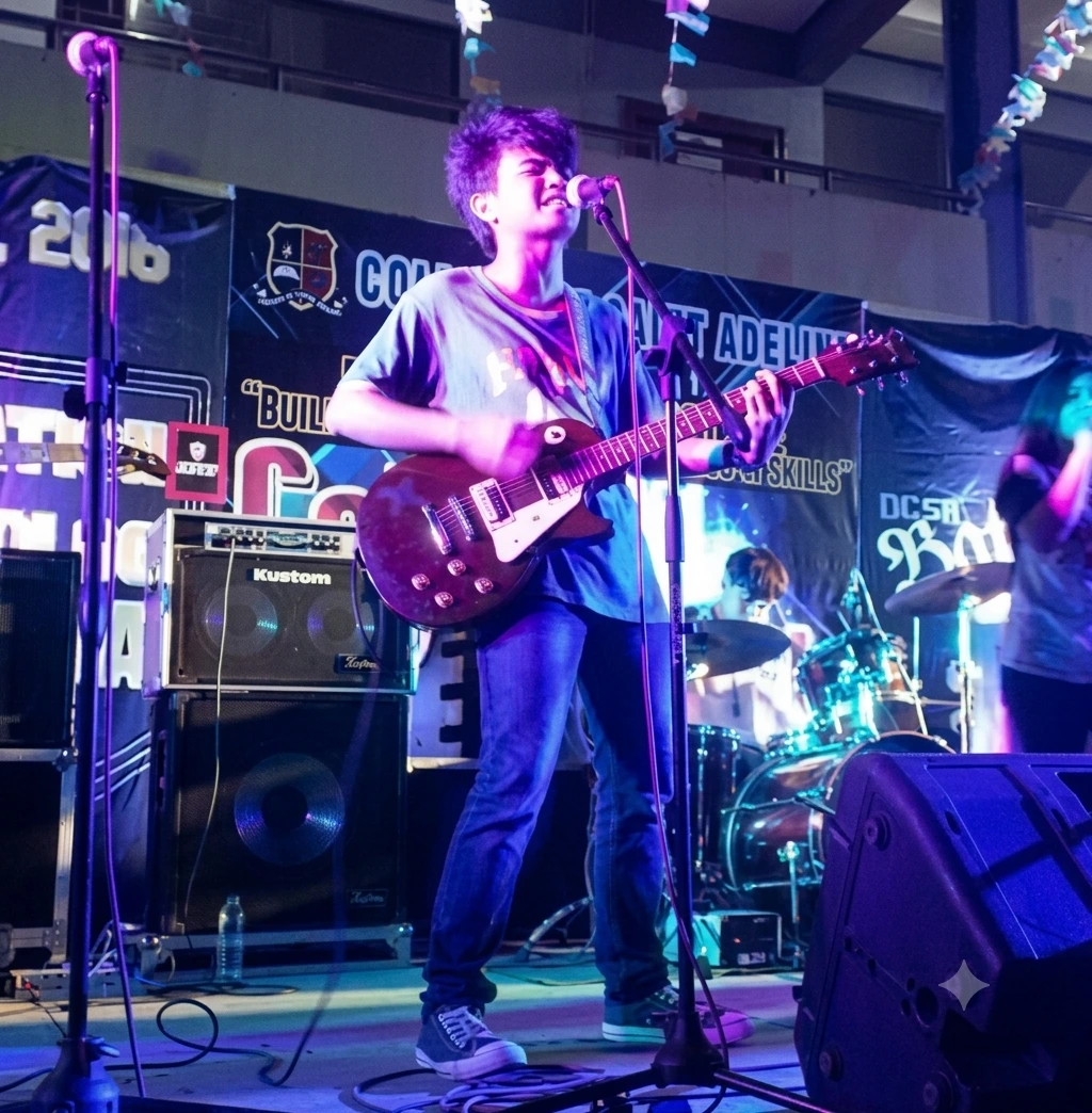 Brian Hiramis playing electric guitar on stage.